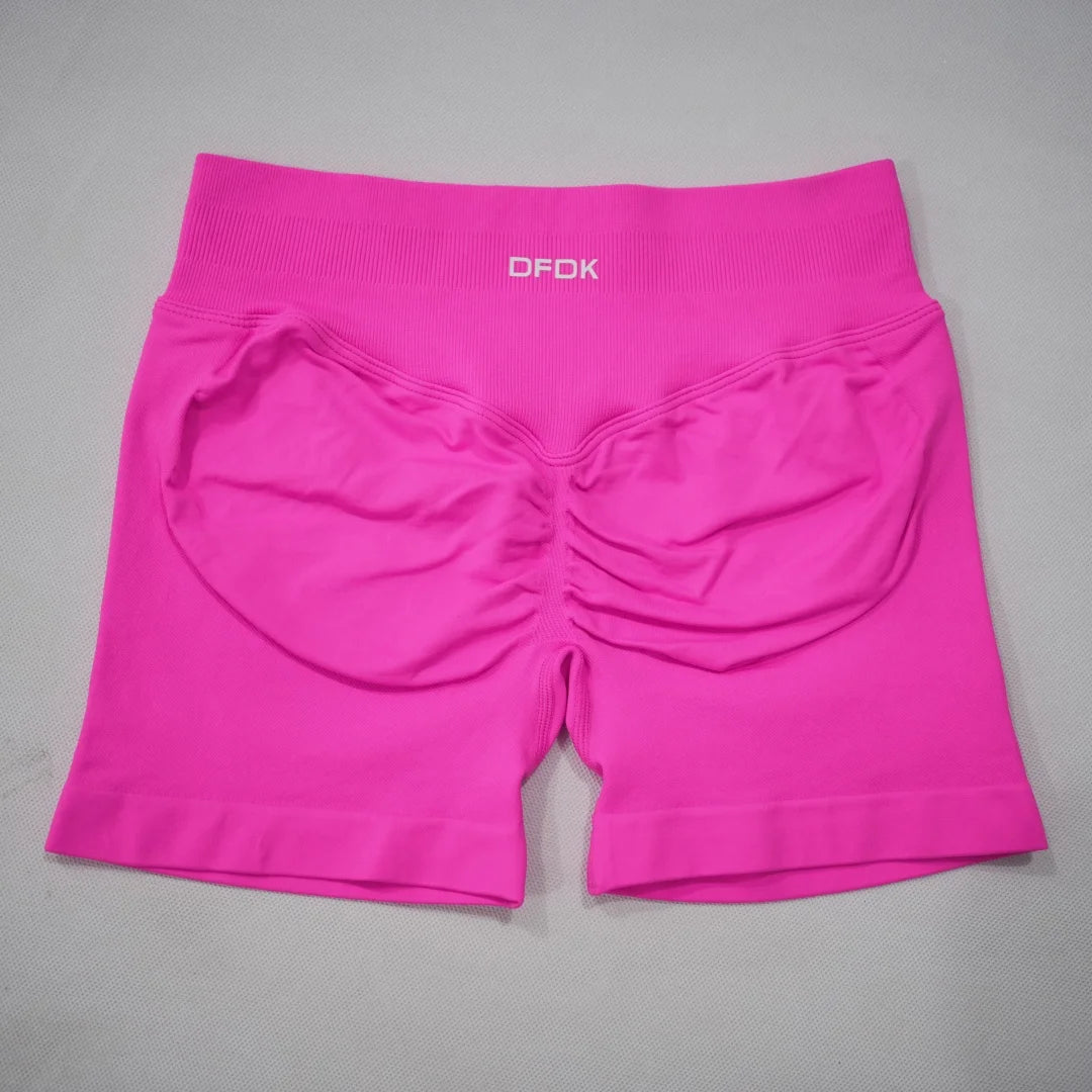 High-waisted gym shorts in vibrant pink with a seamless design and scrunch-butt detail for enhanced contouring.