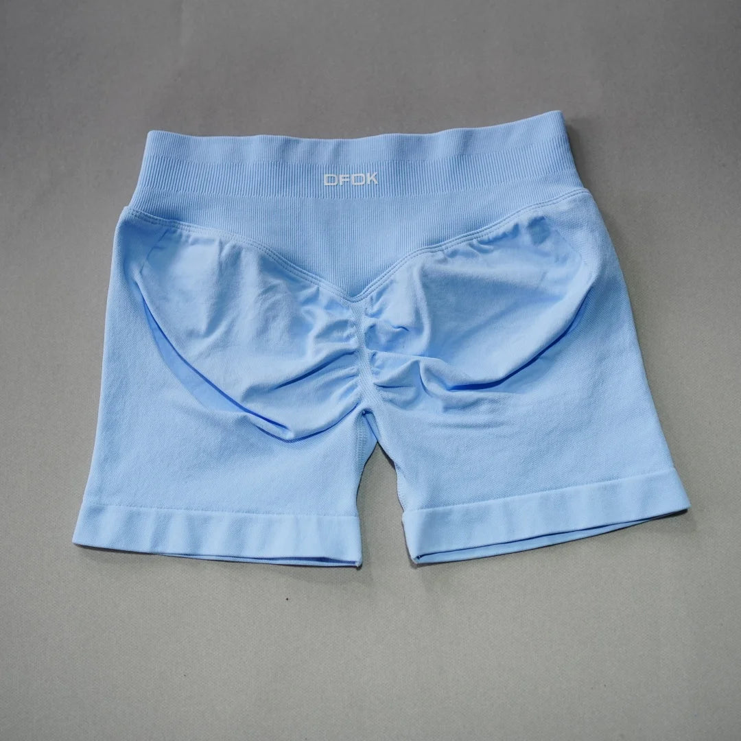 Light blue seamless high-waisted gym shorts featuring a scrunch butt design and wide waistband for added support.