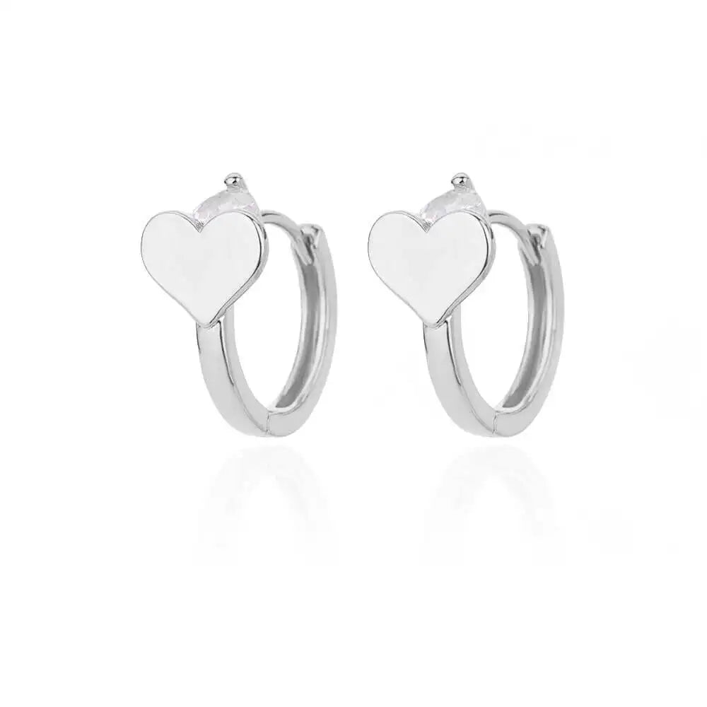 Chunky huggie earrings made from shiny stainless steel, featuring simple heart drop designs in a minimalist style.