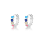 Chunky huggie earrings in stainless steel featuring a heart drop design with blue, navy, beige, and pink enamel accents.