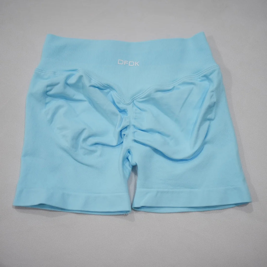Light blue seamless gym shorts featuring a high-waisted design and integrated scrunch-butt detail.