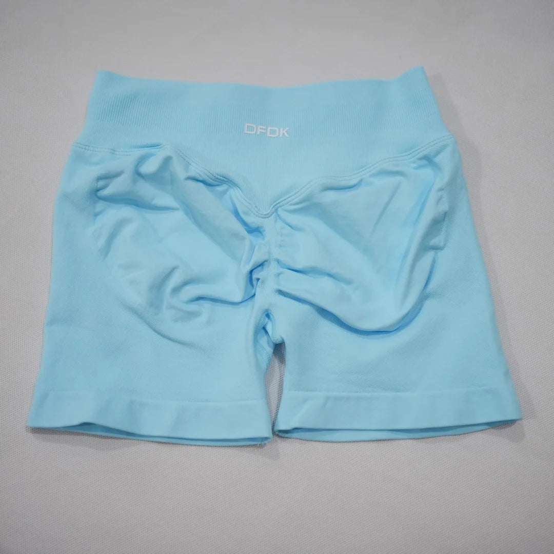 Light blue seamless gym shorts featuring a high-waisted design and integrated scrunch-butt detail.