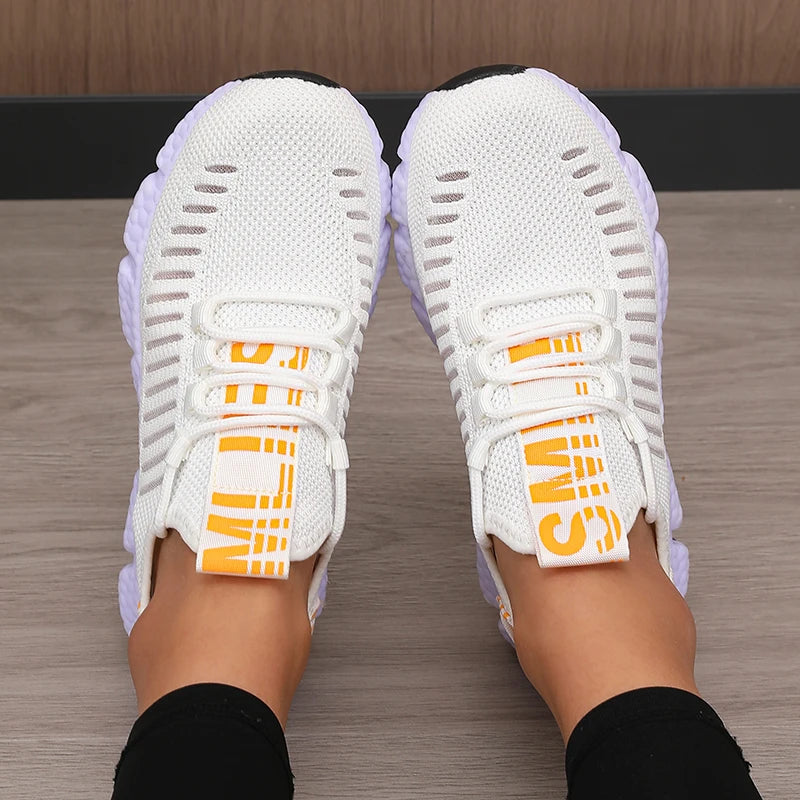 White LOVORA™ Aura Breathable Knitted Performance Sneakers with yellow accents, featuring a stretchy knit upper and lightweight sole.