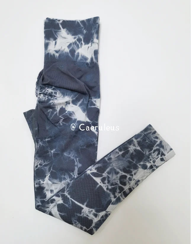 High-waisted leggings in a gray tie-dye pattern, featuring seamless construction and a wide waistband for support.