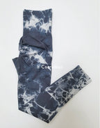 High-waisted leggings in a gray tie-dye pattern, featuring seamless construction and a wide waistband for support.