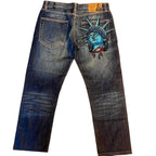 Distressed blue denim jeans with a slouchy fit and oversized wide legs, featuring transparent Liberty Statue embroidery on the back.