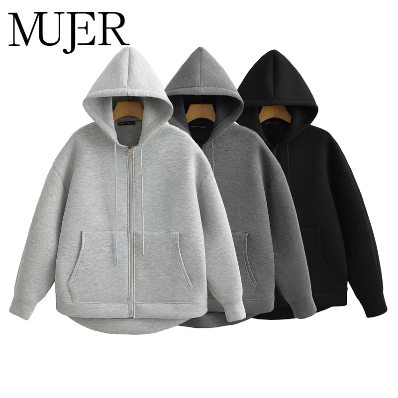 Oversized gray, black, and light gray zip-up hoodies display a relaxed fit, drop shoulders, and front pockets.