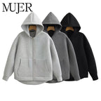 Oversized gray, black, and light gray zip-up hoodies display a relaxed fit, drop shoulders, and front pockets.