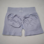High-waisted, light lavender gym shorts with seamless knit fabric and scrunch-butt design for enhanced shape.