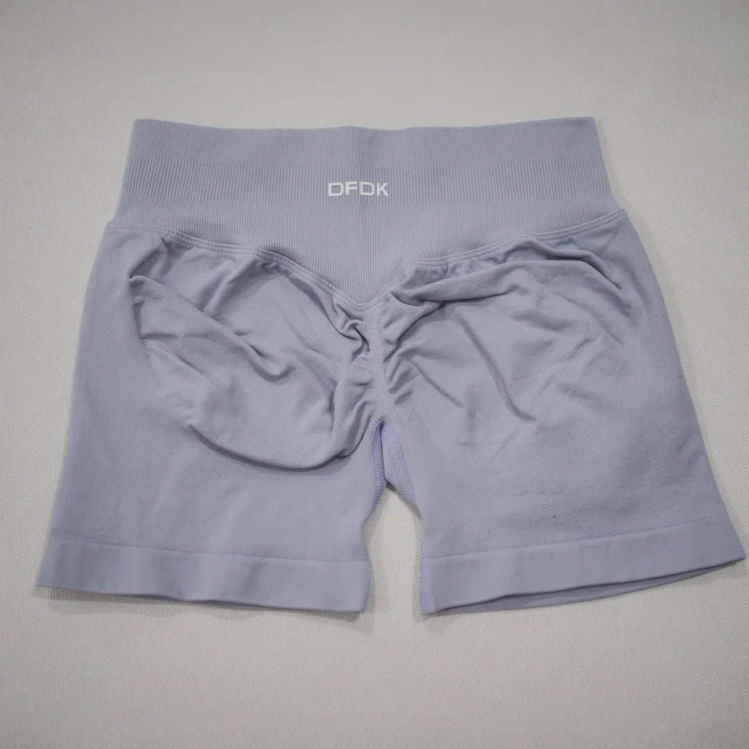 High-waisted, light lavender gym shorts with seamless knit fabric and scrunch-butt design for enhanced shape.