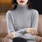 Light gray LOVORA™ Premium Merino Wool & Cashmere turtleneck sweater, featuring a relaxed fit and ribbed trims, worn casually.