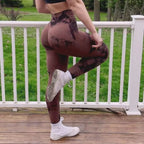High-waisted maroon leggings with contour detailing, featuring a double-layered waistband, styled with a cropped top and white sneakers.