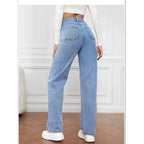 High-waisted wide-leg denim jeans in light blue, featuring a relaxed fit and elastic waist, paired with white sneakers.