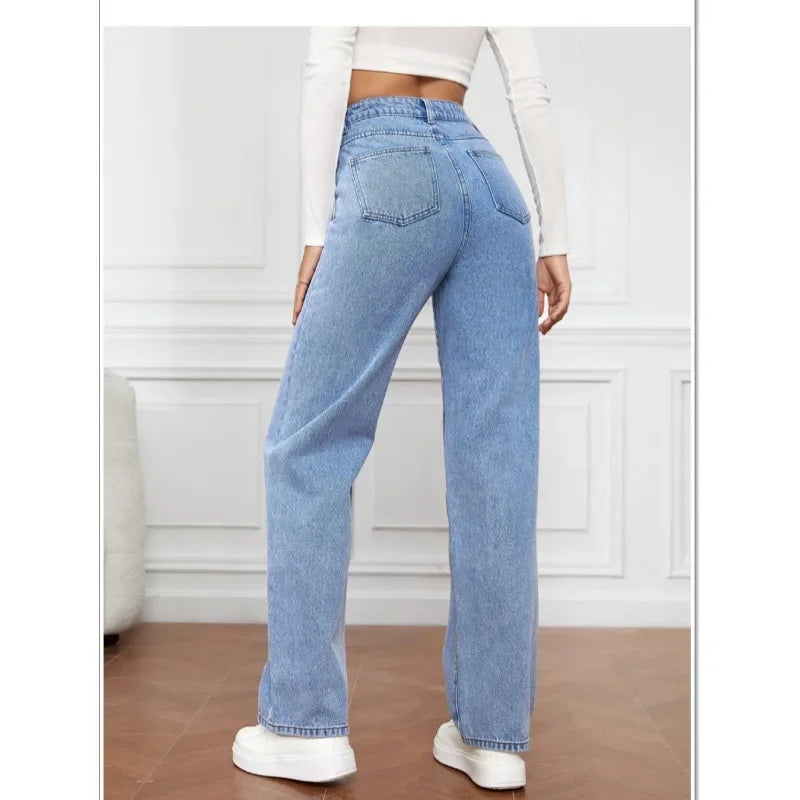 High-waisted wide-leg denim jeans in light blue, featuring a relaxed fit and elastic waist, paired with white sneakers.