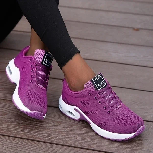 Purple LOVORA™ Aura Air Boost Platform Sneakers featuring a breathable mesh upper and air-cushion heel, styled with black leggings.
